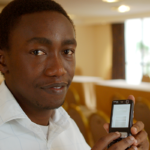 Kenyan man with mobile phone